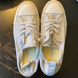 Converse white and light gray gym shoes.